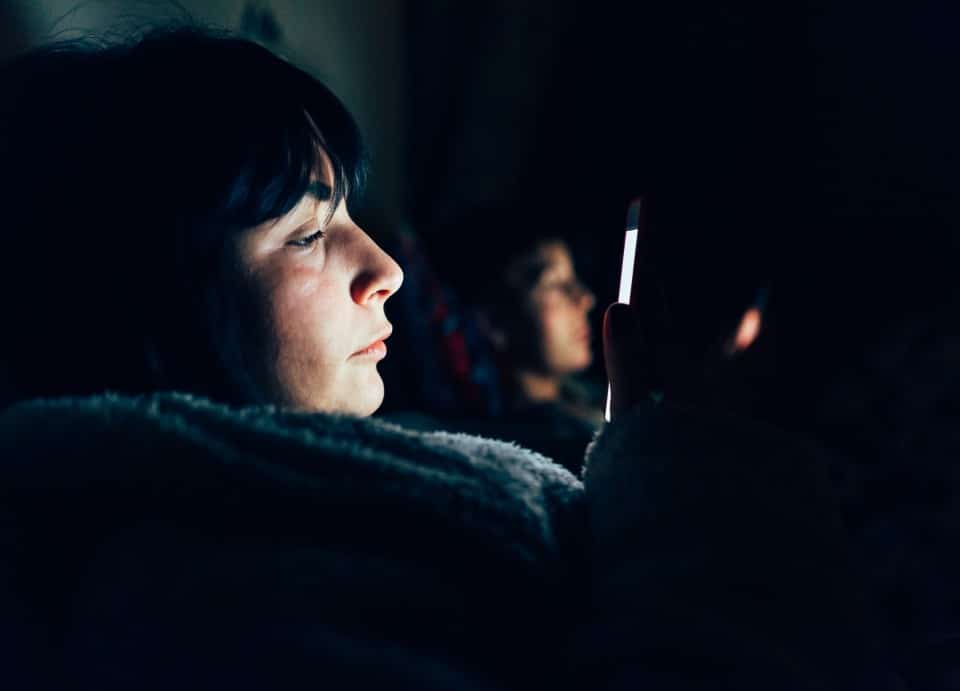 women-in-bed-in-darkness-using-mobile-phones-2024-10-18-09-16-07-utc-1